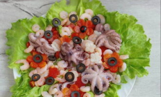 Distribute the olive rings and sprinkle the salad with lemon juice and olive oil.