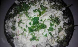 Salad with squid, crab sticks and egg is ready. Garnish with aromatic herbs and serve!