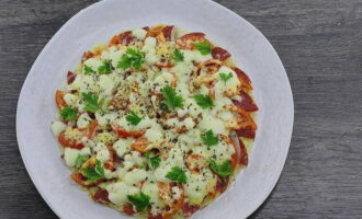 Carefully transfer the hot appetizer to a flat plate. Chop the greens and sprinkle on top.