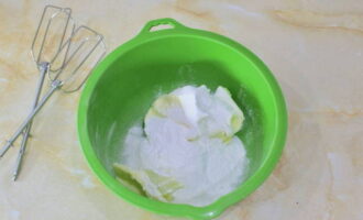 Place soft butter in a container and add powdered sugar.