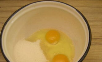 Choose a suitable saucepan or saucepan for cooking the cream. Break eggs here and add granulated sugar.