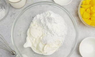 In a large container using a mixer, mix cold sour cream with vanilla sugar and powdered sugar. The whipping speed should be maximum.